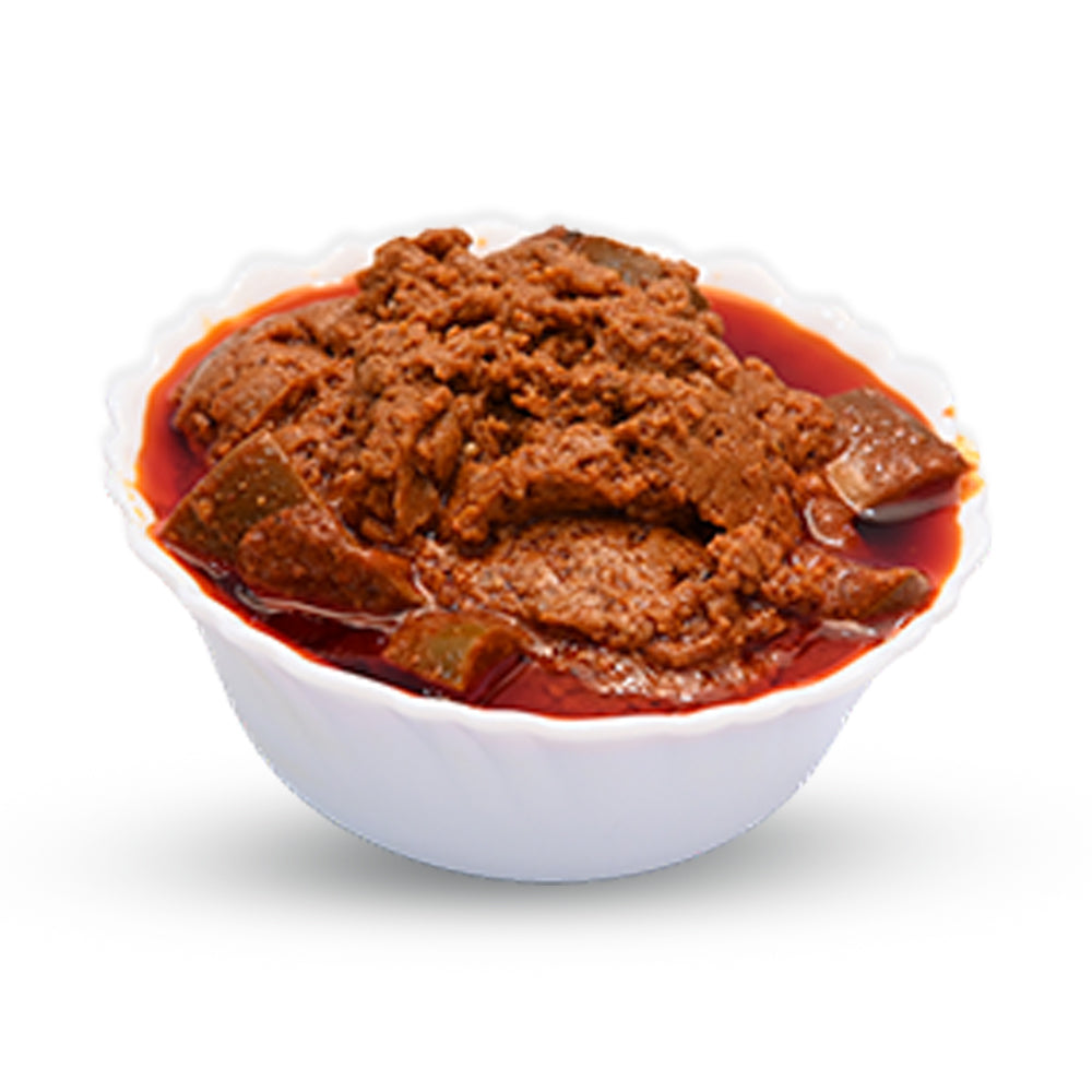 Bowl of Bellam Avakaya (Sweet Mango Pickle) with thick gravy and red oil.